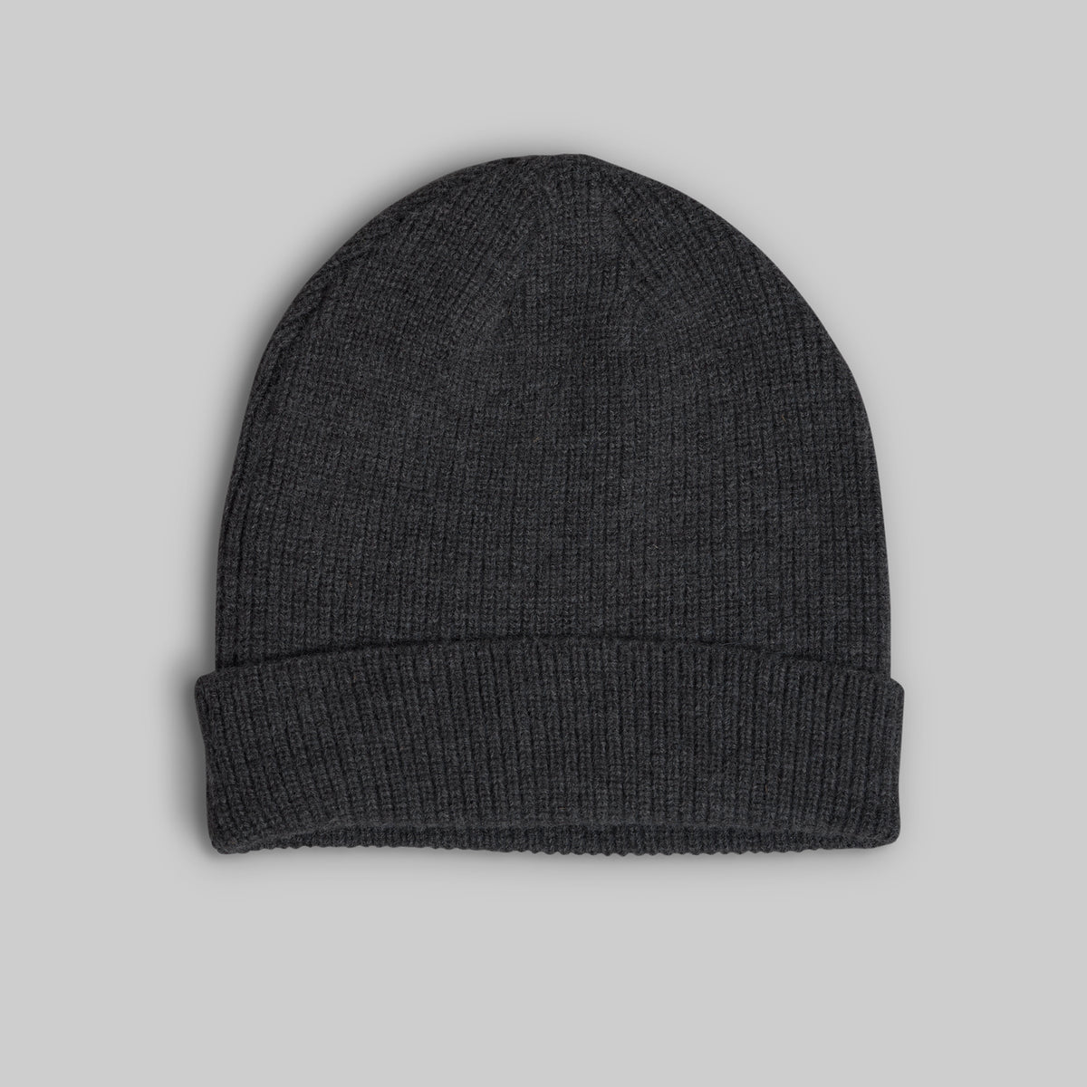 A dark charcoal gray ribbed knit beanie hat with a folded cuff, shown flat against a solid light gray background.