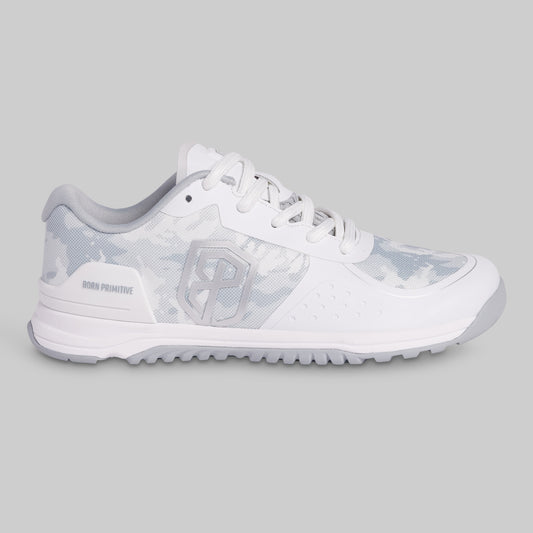 White athletic shoe with a patterned sole on a gray background