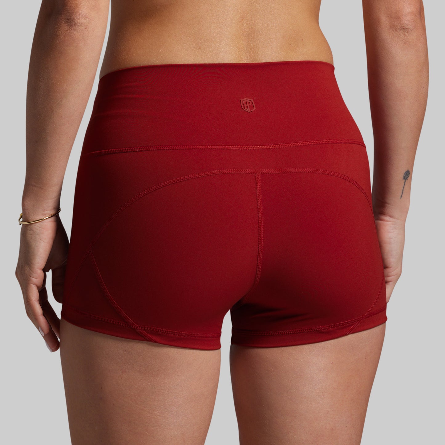 Red athletic shorts worn by a person on a plain background