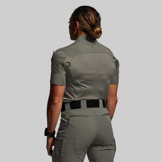 Person wearing a green uniform with a plain background