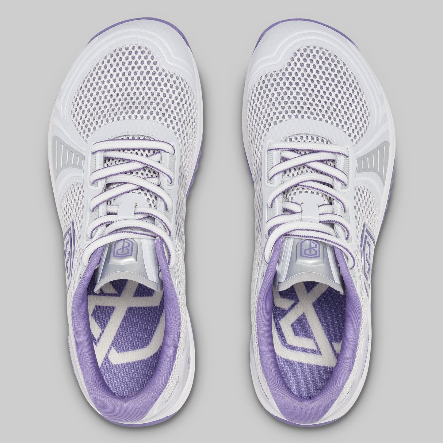 White and purple running shoes on a gray background