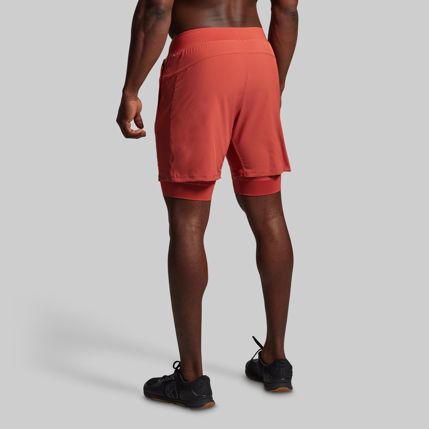 Person wearing red athletic shorts on a plain background