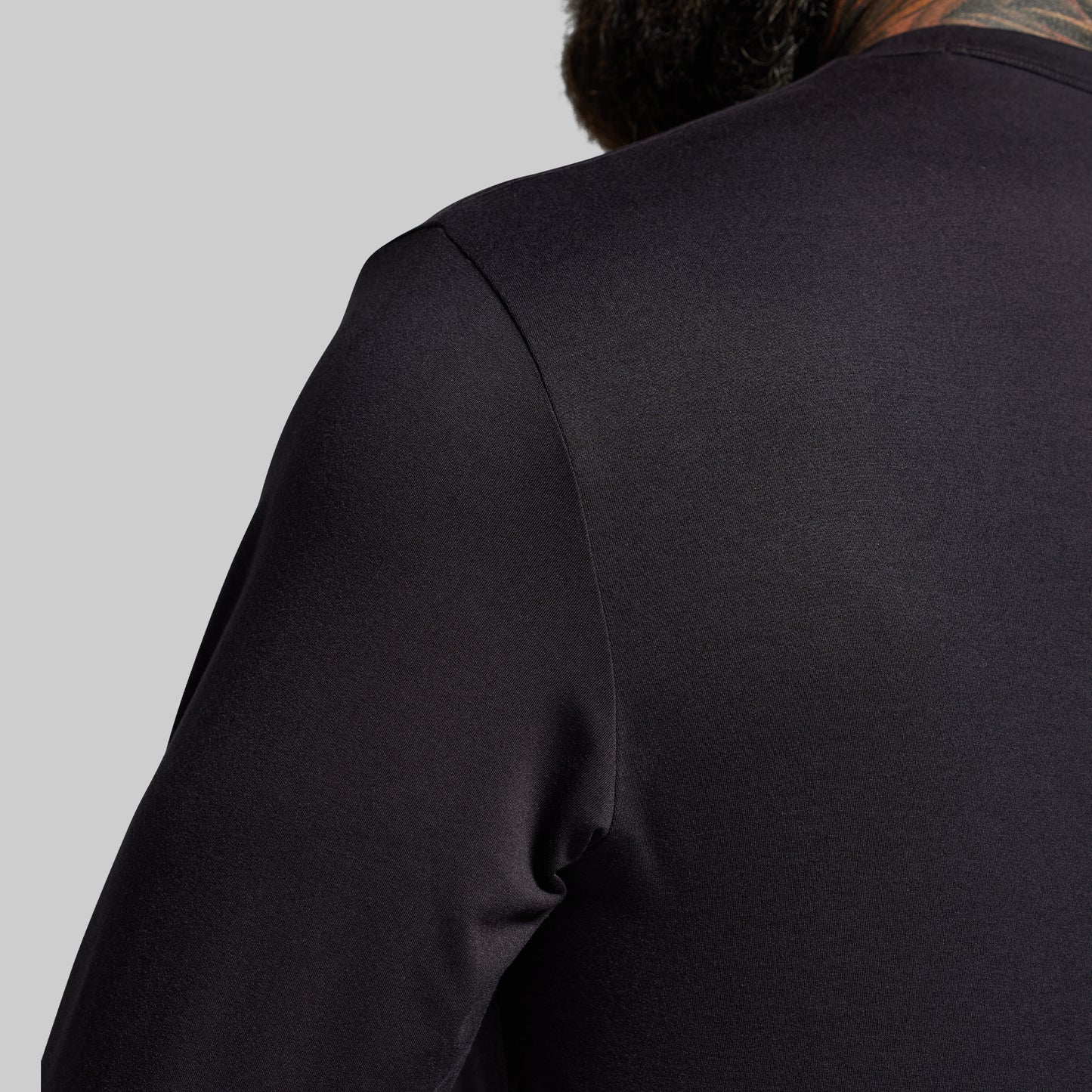 Black long-sleeve shirt on a gray background