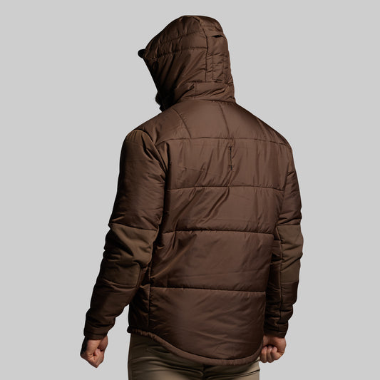 Brown puffer jacket worn by a person on a light gray background