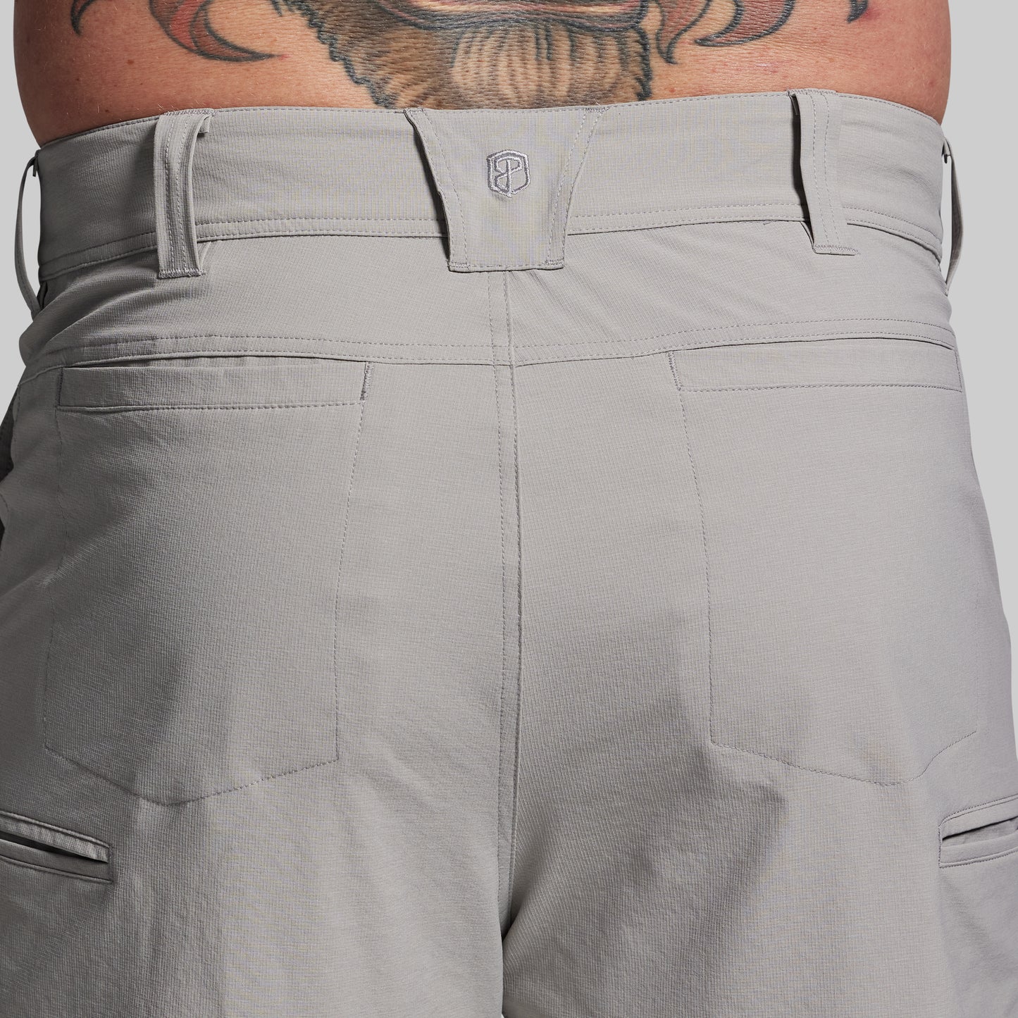 Gray shorts with a brand logo on a plain background