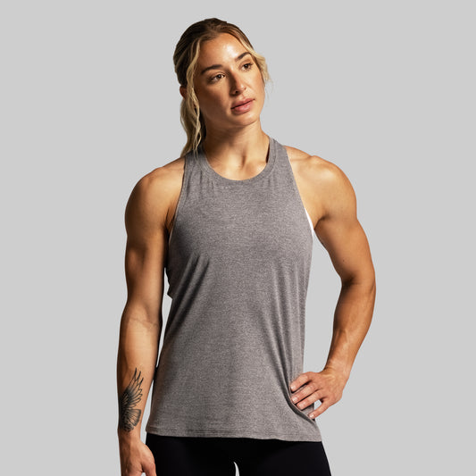 Person wearing a gray tank top against a plain background