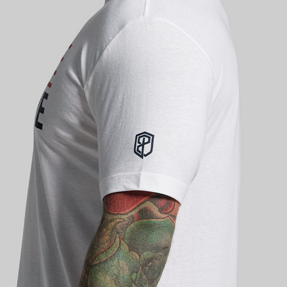 Person wearing a white athletic shirt with a logo on a plain background