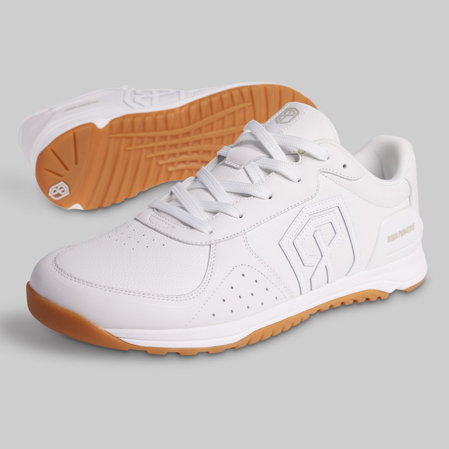 White sneakers with brown soles on a gray background
