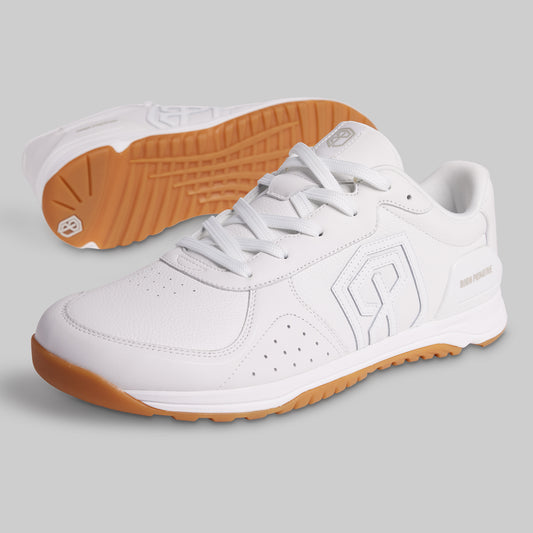 White sneakers with brown soles on a gray background
