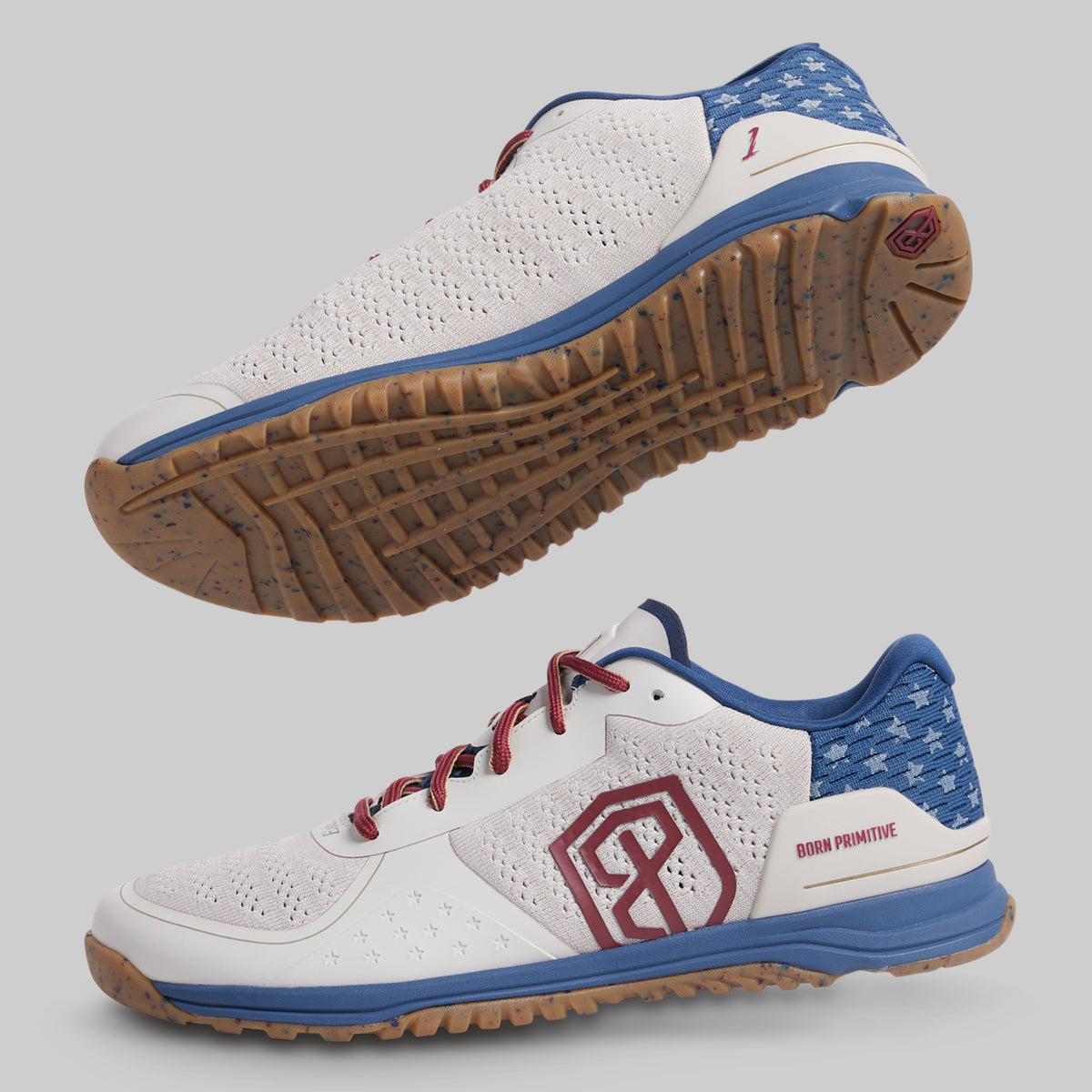 White athletic shoe with blue and red accents on a gray background
