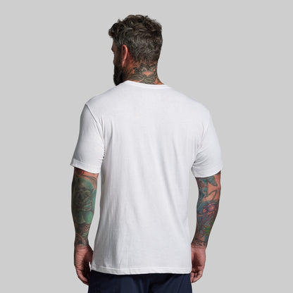 Man wearing a plain white t-shirt against a gray background