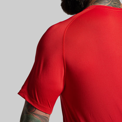 Red athletic shirt worn by a person on a gray background