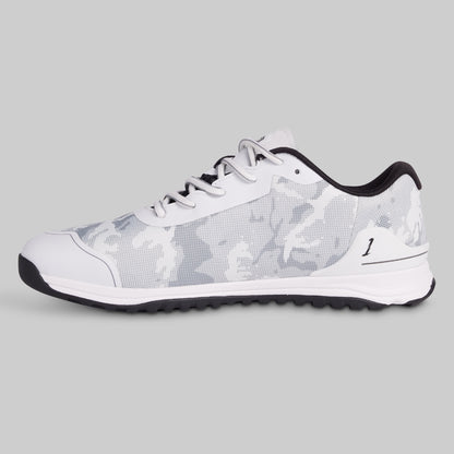 White sneaker with black sole on a gray background