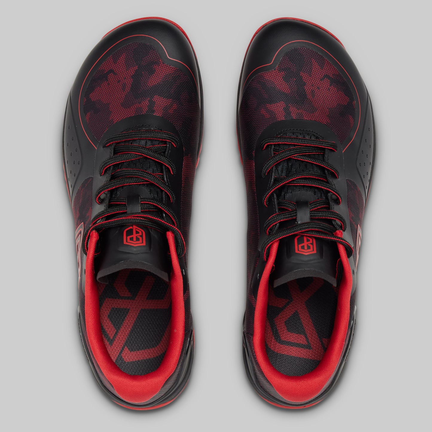Black and red sneakers on a gray background