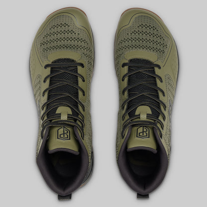Pair of green athletic shoes with black laces on a light gray background