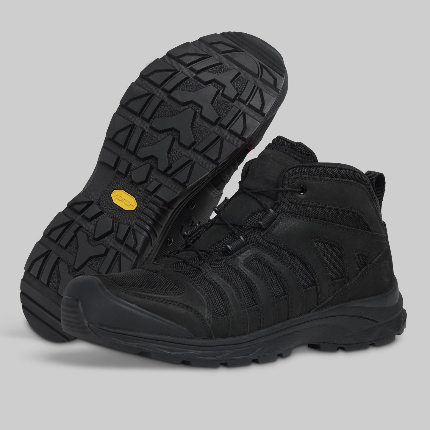 Black boots with a yellow label on a gray background