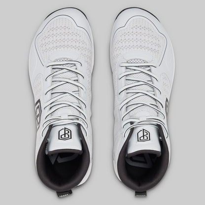 Pair of white sneakers with black soles on a light gray background