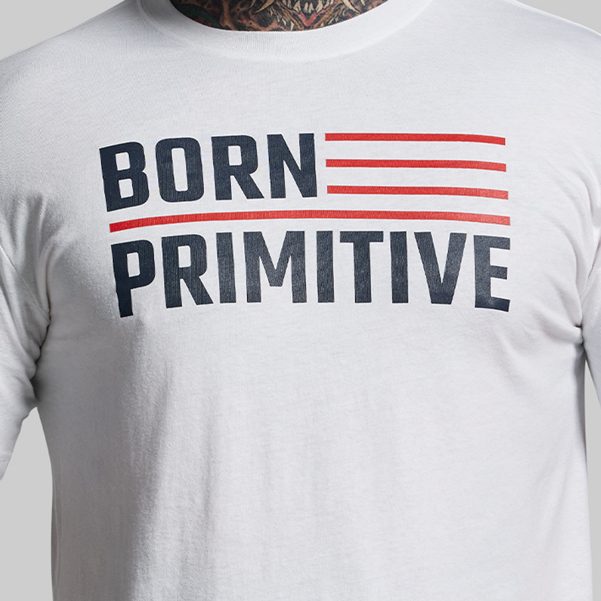 White t-shirt with 'Born Primitive' text design on a plain background