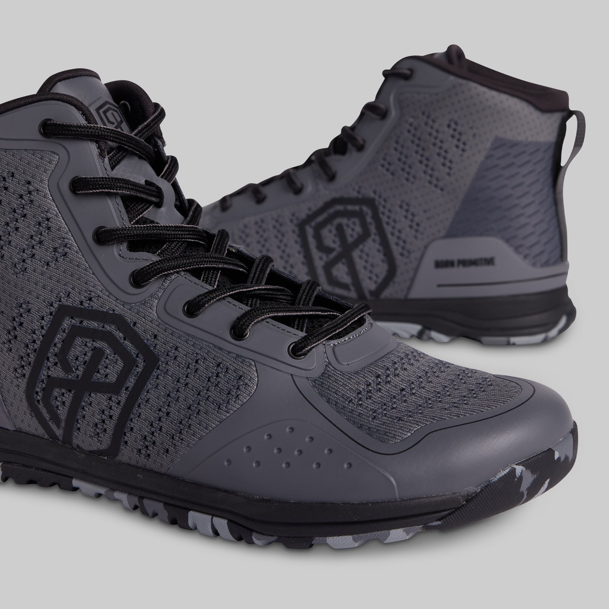 Gray high-top sneakers with black accents on a light gray background