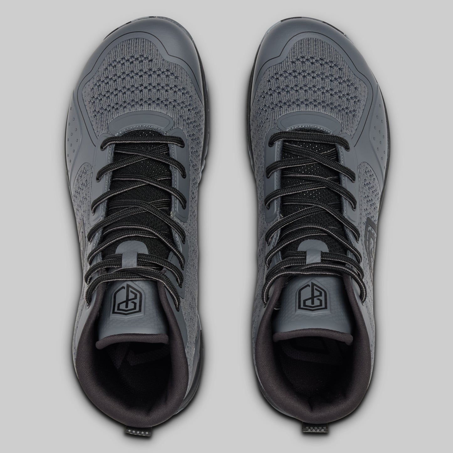 Pair of gray athletic shoes on a light gray background