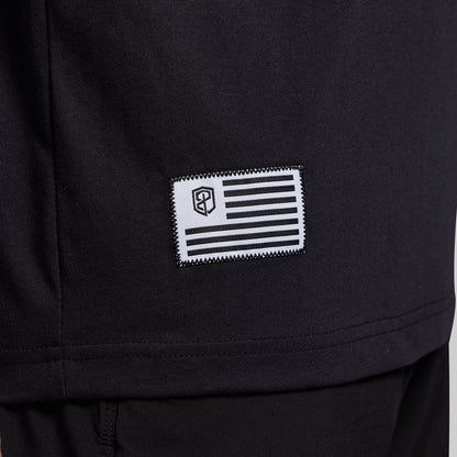 Black t-shirt with a flag patch on lower corner