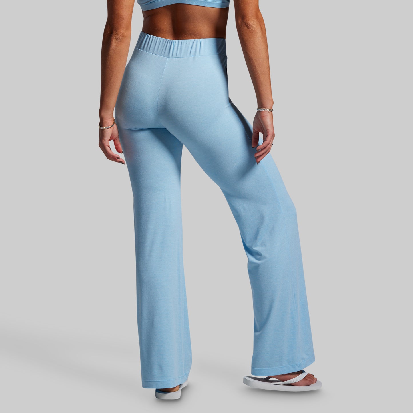 Light blue wide-leg pants worn by a person on a gray background