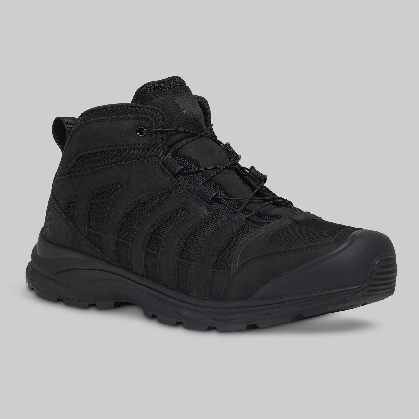 Black tactical boot on a gray background