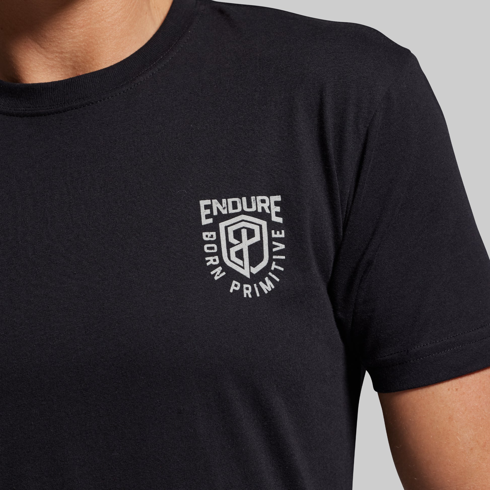Black t-shirt with a white logo on a gray background