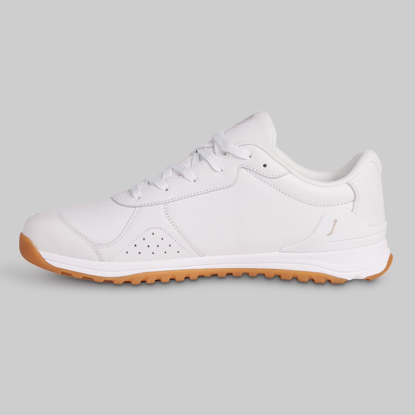 White sneaker with brown sole on a light gray background