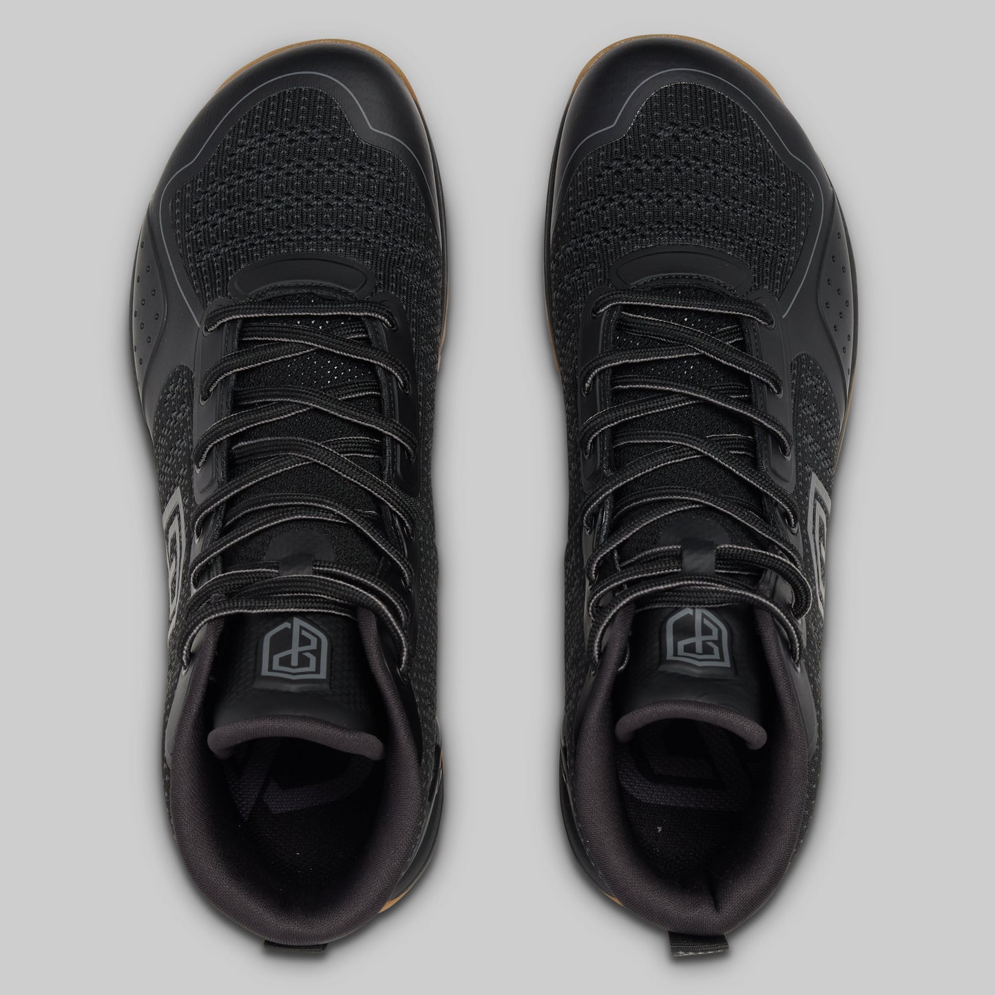 Black athletic shoes on a light gray background