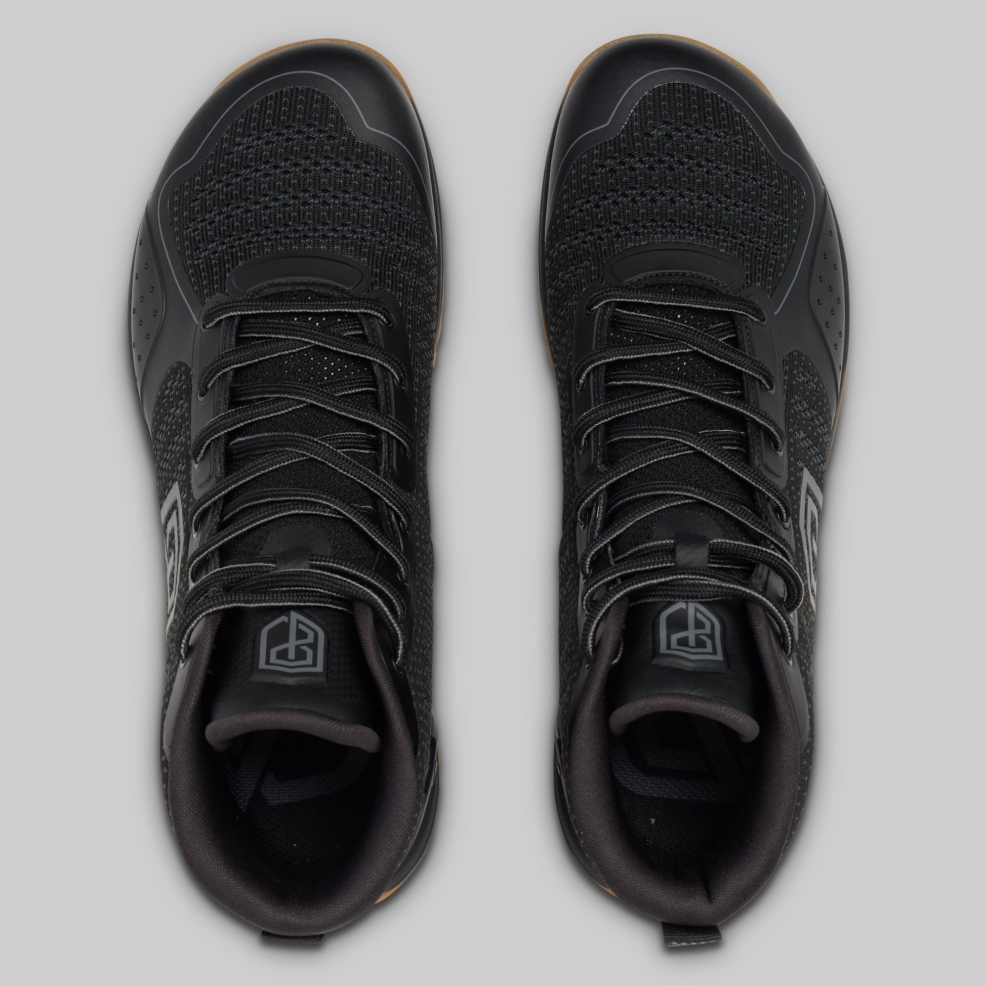 Black athletic shoes on a light gray background