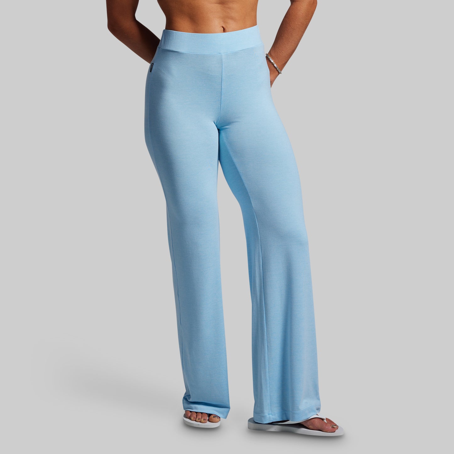 Light blue wide-leg pants worn by a person on a gray background