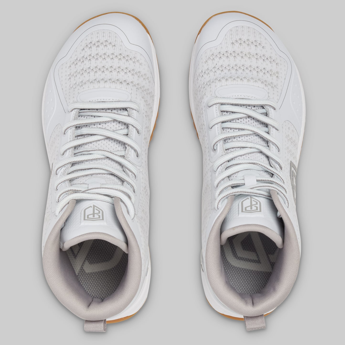 Pair of white sneakers on a light gray background