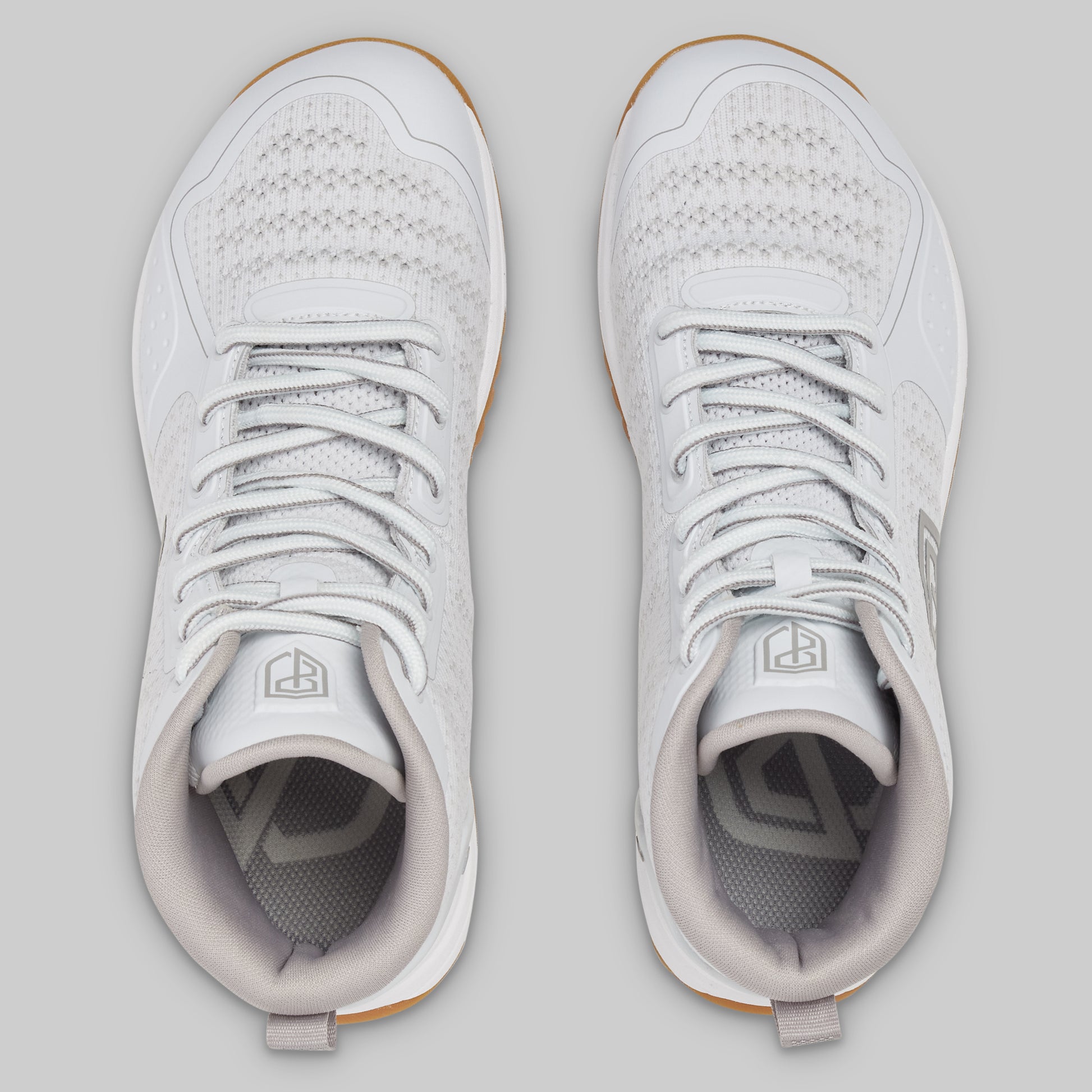 Pair of white sneakers on a light gray background