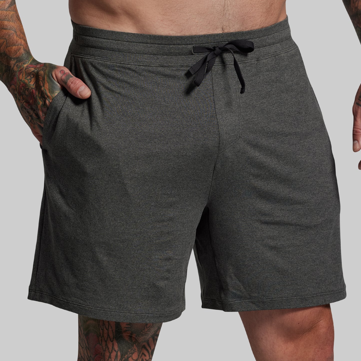 Gray shorts with a drawstring on a plain background