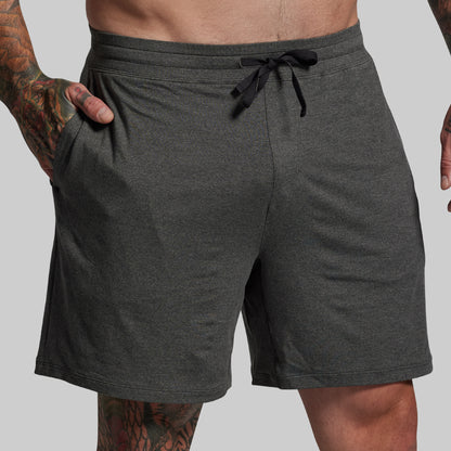 Gray shorts with a drawstring on a plain background