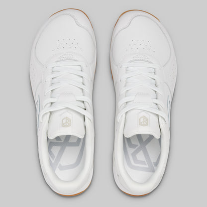White sneakers with a brand logo on a gray background