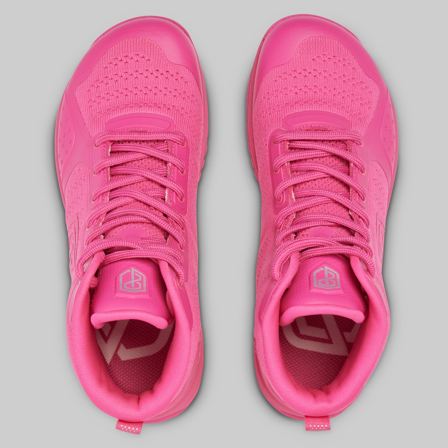 Pair of pink athletic shoes on a gray background