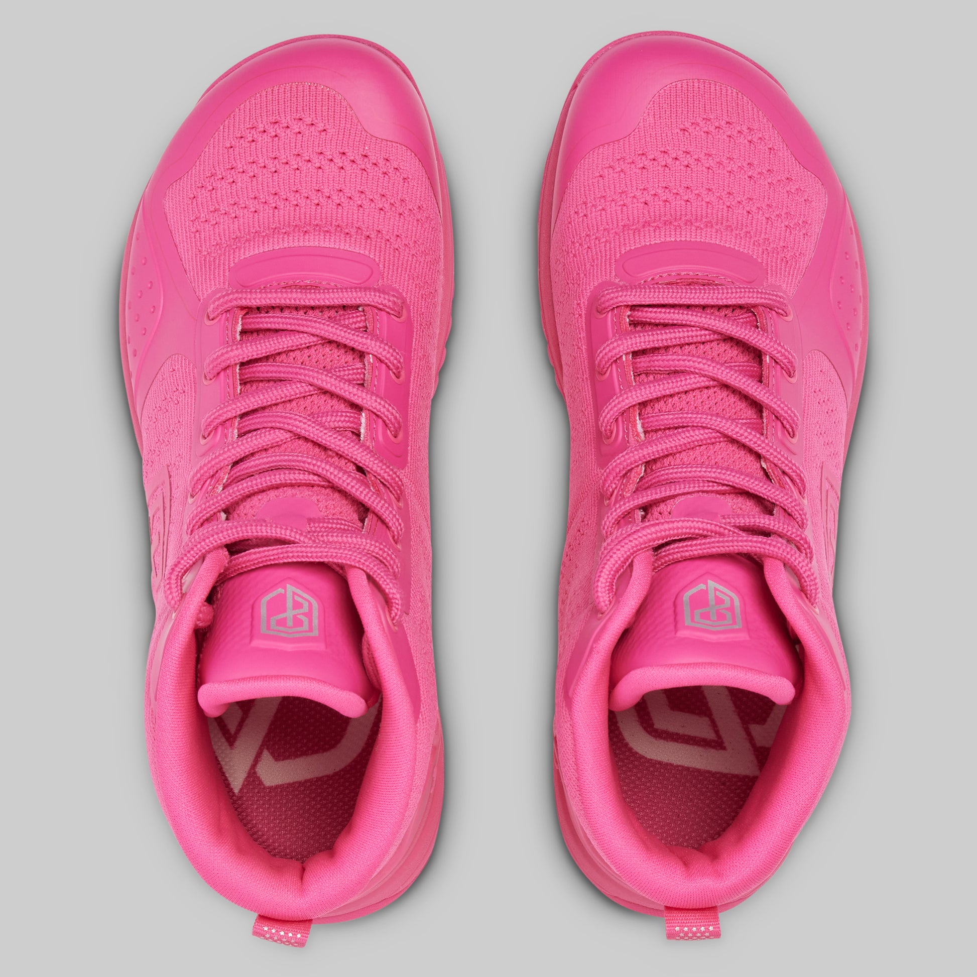 Pair of pink athletic shoes on a gray background
