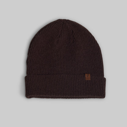 A dark brown ribbed knit beanie hat with a small brown leather logo patch on the side, displayed against a neutral gray background.