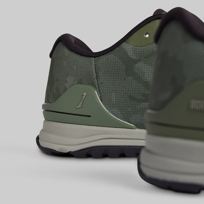 Green athletic shoe with brand logo on a light gray background