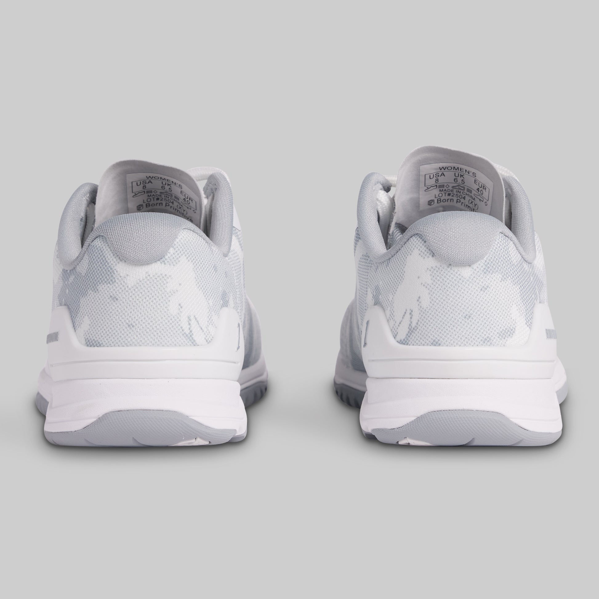 White sneakers with a logo on a light gray background