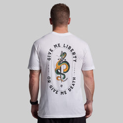 Person wearing a white t-shirt with a snake graphic and text on the back against a gray background