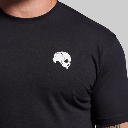 Black t-shirt with a white skull design on a gray background