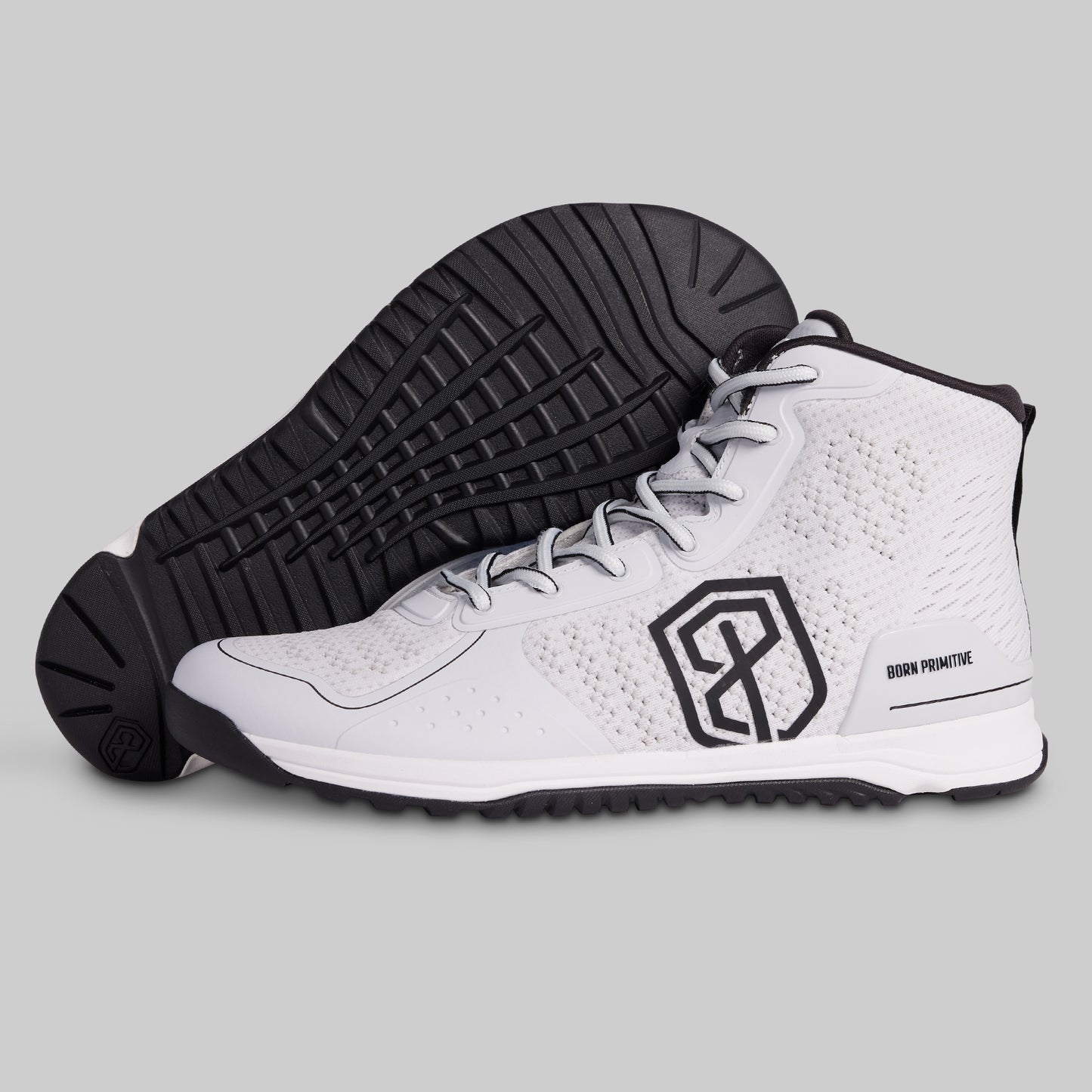 White high-top sneakers with black sole and logo on a gray background