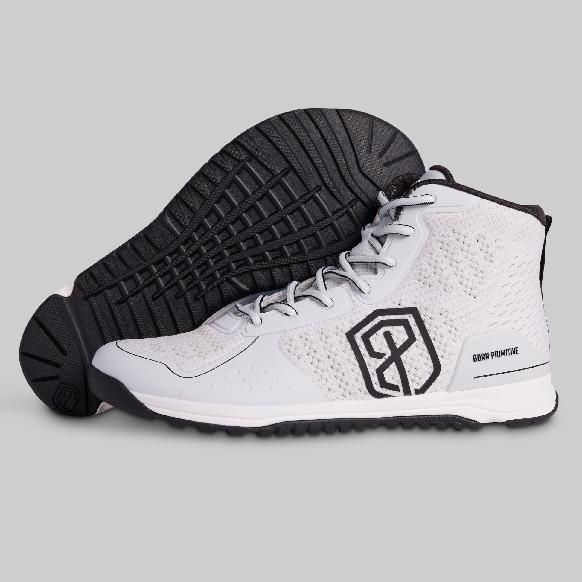 White high-top sneakers with black sole and logo on a gray background