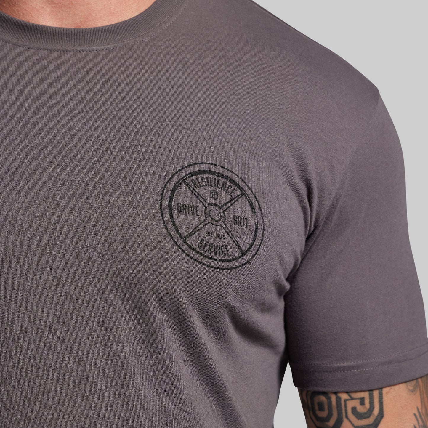 Gray t-shirt with a black circular logo on a gray background