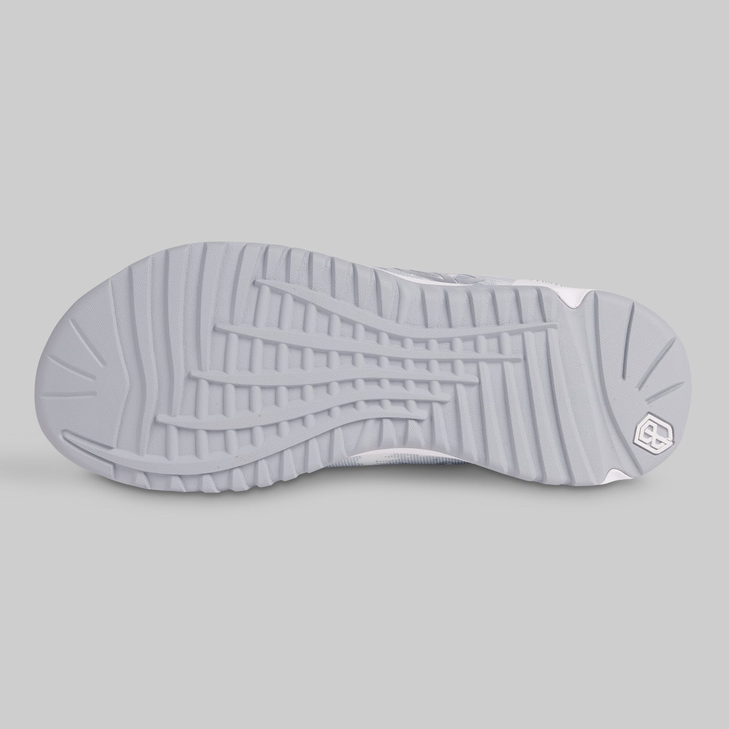 Close-up of a gray sneaker sole with a brand logo on a light gray background