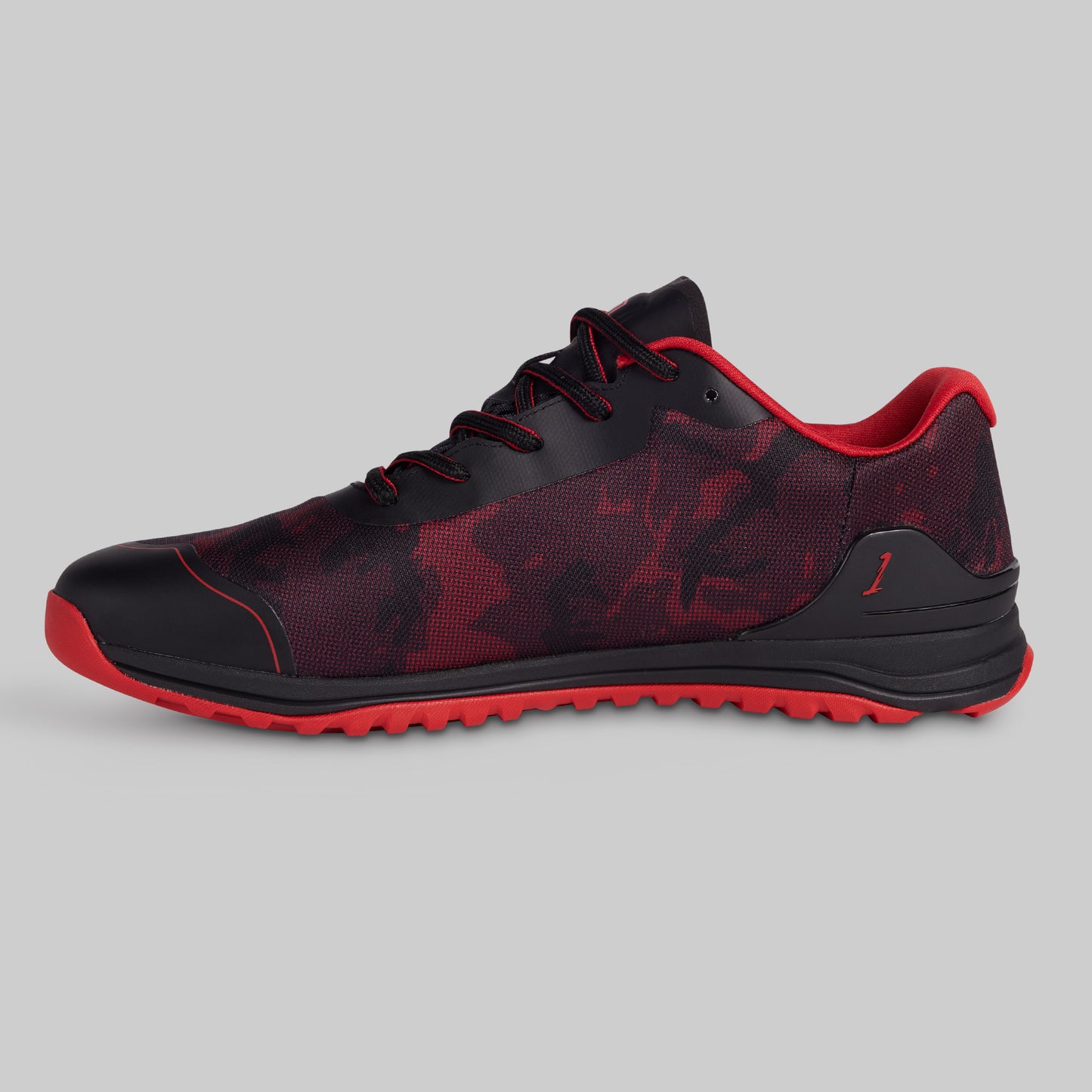 Black and red athletic shoe on a gray background