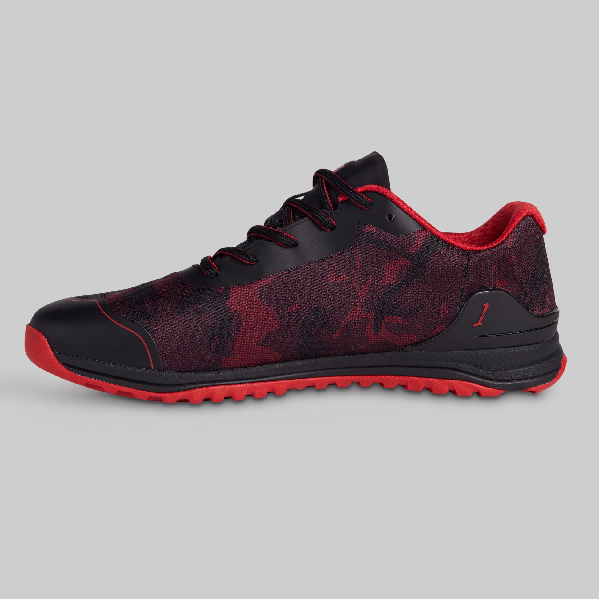 Black and red athletic shoe on a gray background